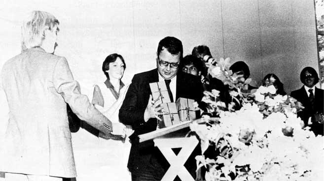 Mr. Vadala handing out presents at graduation.